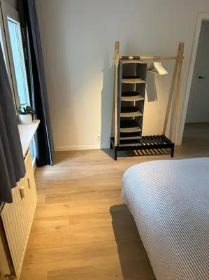 a room with a bed and a wooden floor at Ghent by the water in Ghent