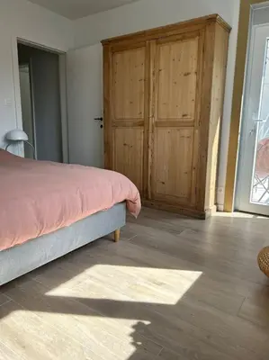 a bedroom with a bed and a wooden door at Ghent by the water in Ghent