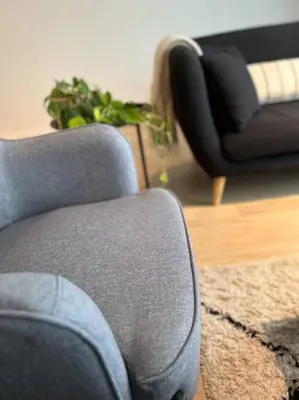 a living room with a chair and a couch at Ghent by the water in Ghent