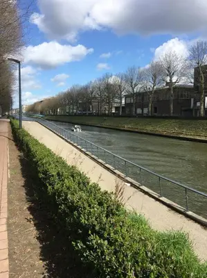 a body of water with a fence next to a river at Ghent by the water in Ghent