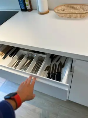 a person reaching into an open drawer in a kitchen at Ghent by the water in Ghent