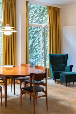 a dining room with a table and chairs at Pauline Loveling apartment with quiet garden and 2 bathrooms in Antwerp