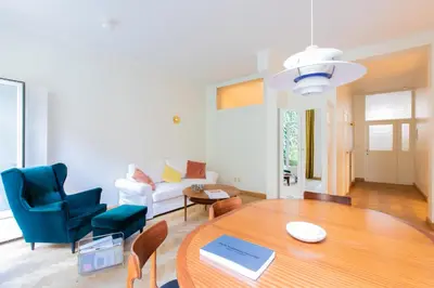 a living room with a table and a couch at Pauline Loveling apartment with quiet garden and 2 bathrooms in Antwerp