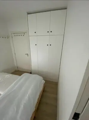 a bedroom with white cabinets and a bed in it at Business Accommodation Luxury XL Geel in Geel