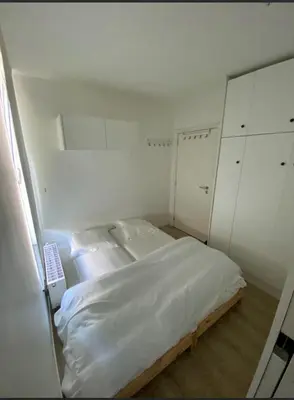 a white bedroom with a bed and white cabinets at Business Accommodation Luxury XL Geel in Geel