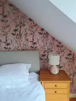 a bedroom with a bed and a table with a lamp at Maison Patisson in Kasterlee
