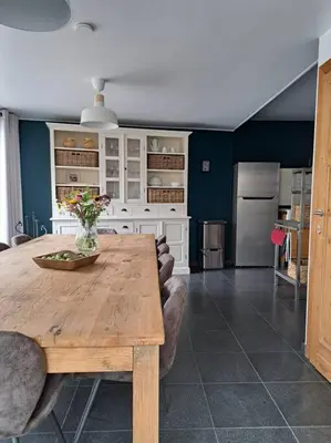 a kitchen with a wooden table in a room at Maison Patisson in Kasterlee