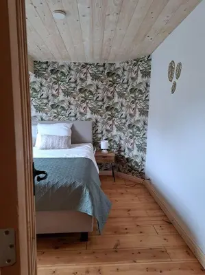 a bedroom with a bed in a room with a wall at Maison Patisson in Kasterlee