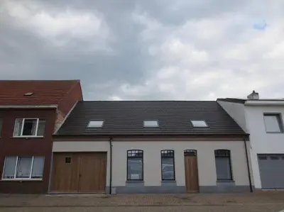 a white house with a brown roof at Maison Patisson in Kasterlee