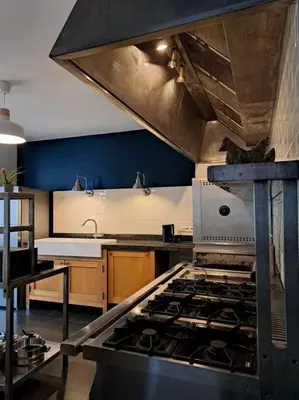 a kitchen with a stove top oven in a kitchen at Maison Patisson in Kasterlee