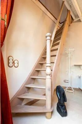 a wooden staircase in a room with at Carriage House in quiet ecological garden in Antwerp