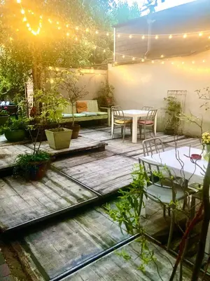 a patio with a table and chairs and lights at foodiejive appartement 2 in Antwerp