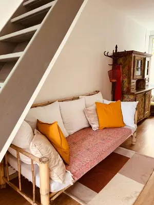 a couch with pillows on it in a living room at foodiejive appartement 2 in Antwerp