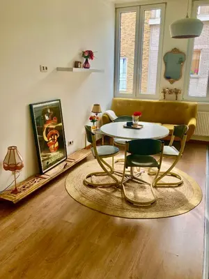 a living room with a table and chairs at foodiejive appartement 2 in Antwerp