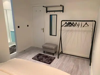 a bedroom with a bed and a room with a door at Royal South - Apartment Antwerp with Parkview in Antwerp