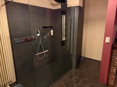 a shower with a glass door in a bathroom at B&B Oase in Londerzeel