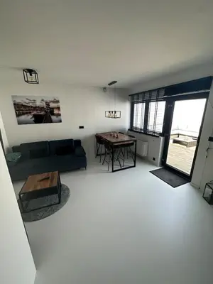 a living room with a couch and a table at Antwerp West Side, TERRACE in Zwijndrecht