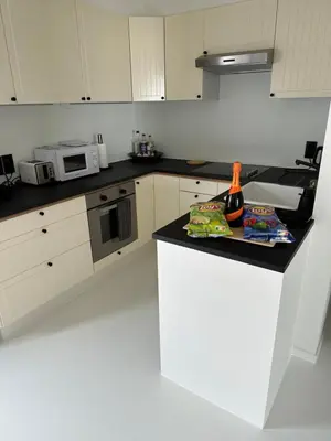 a kitchen with a counter with a bottle of wine on it at Antwerp West Side, TERRACE in Zwijndrecht
