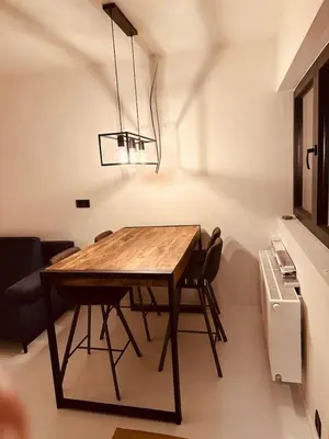 a dining room table with chairs and a chandelier at Antwerp West Side, TERRACE in Zwijndrecht
