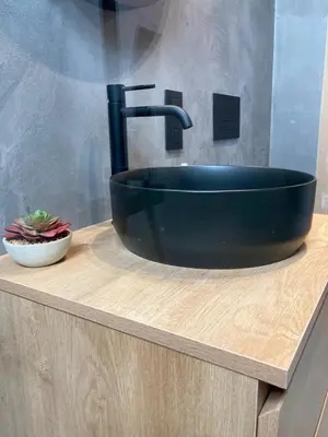 a black sink on a wooden counter in a bathroom at Chez Roya in Zaventem