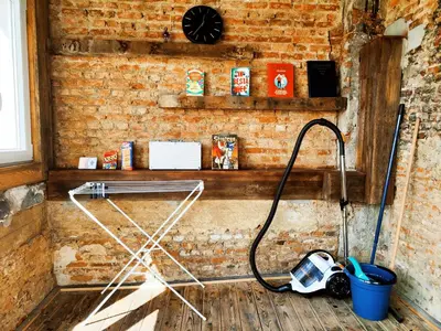 a bathroom with a hose hooked up to a brick wall at Rooftop apartment with 60m terrace overlooking the cathedral in Antwerp