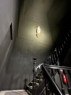 a stairway with a light on the ceiling and a stair case at Rooftop apartment with 60m terrace overlooking the cathedral in Antwerp