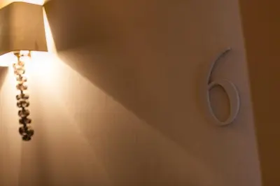 a light on a wall with a number on it at B&B Louis1924 in Dilbeek