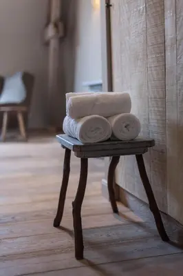 a pile of towels on a table in a bathroom at B&B Louis1924 in Dilbeek
