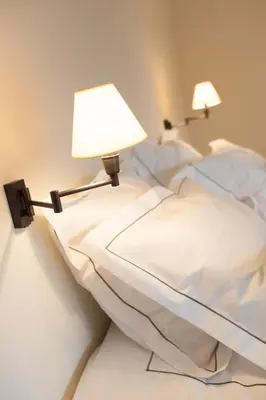a bedroom with a bed with two lamps on it at B&B Louis1924 in Dilbeek