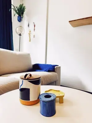 a table with two containers on top of a living room at Historic Center Apartment Walk to Everything in Ghent
