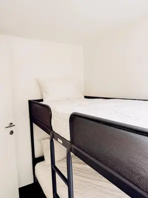 a black bunk bed in a white room at Historic Center Apartment Walk to Everything in Ghent