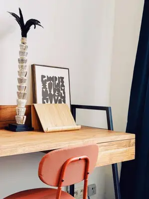 a wooden desk with a chair and a plant on it at Historic Center Apartment Walk to Everything in Ghent