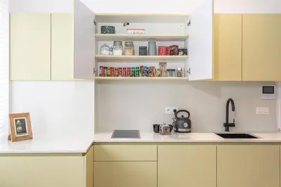 a kitchen with white cabinets and a sink at Beautiful studio in Antwerp