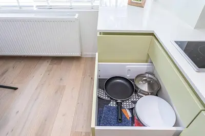 a kitchen with two pots and pans in a drawer at Beautiful studio in Antwerp