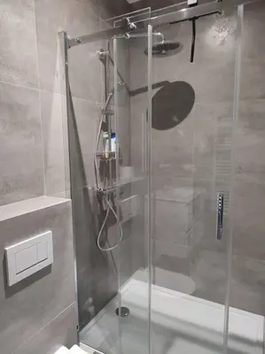 a shower with a glass door in a bathroom at Beautiful studio in Antwerp