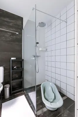 a bathroom with a toilet and a glass shower at Right In The City Center Your Ghent Getaway in Ghent