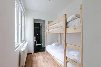 a bedroom with two bunk beds and a window at Right In The City Center Your Ghent Getaway in Ghent