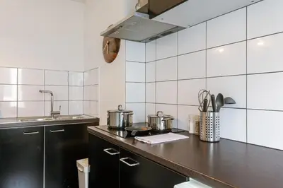 a kitchen with pots and pans on a counter at Right In The City Center Your Ghent Getaway in Ghent