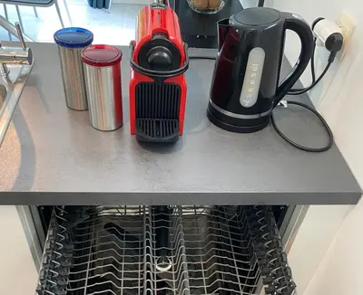 a counter top with a coffee maker and cups on it at Bella Vie, rust en ontspanning in Haacht