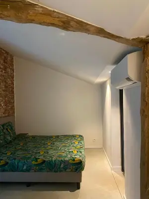 a small bedroom with a bed in a room at Hoeve De Kleinheide - De Schuur in Dessel