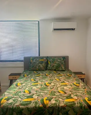 a bedroom with a bed with a colorful bedspread at Hoeve De Kleinheide - De Schuur in Dessel