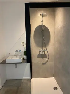 a bathroom with a shower and a sink at Hoeve De Kleinheide - De Schuur in Dessel