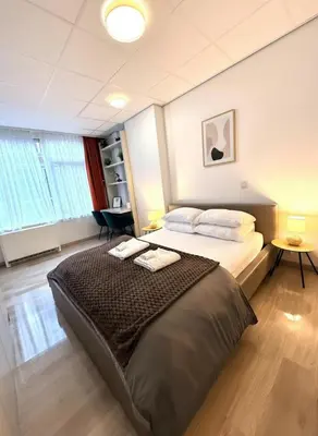 a bedroom with a bed with two towels on it at Heart of Grand Place Beautiful Studio in Brussels