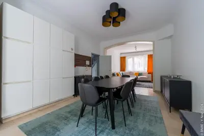 a kitchen and dining room with a table and chairs at La Louve - Big Place & Garden - Parking Gratuit in Brussels
