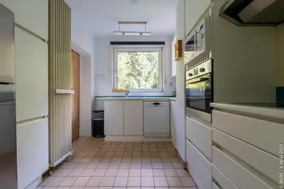 a kitchen with a sink and a window at La Louve - Big Place & Garden - Parking Gratuit in Brussels