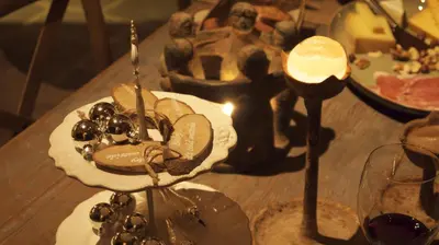 a table with a candle and a plate of food at B&B Hemel & Haard in Assenede