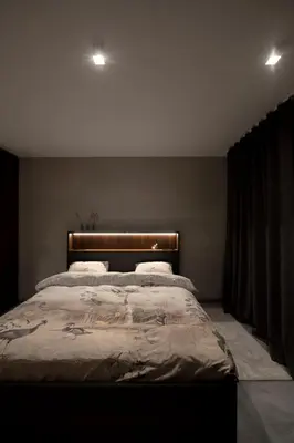 a bedroom with a large bed with a wooden headboard at Nuit Blanche in Oud-Heverlee