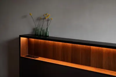 a wooden cabinet with three vases with flowers in it at Nuit Blanche in Oud-Heverlee