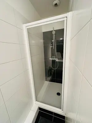 a shower with a glass door in a bathroom at Urbanstay Suites - Grand Place 2 Bd Penthouse in Brussels