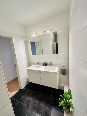 a white bathroom with a sink and a mirror at Urbanstay Suites - Grand Place 2 Bd Penthouse in Brussels